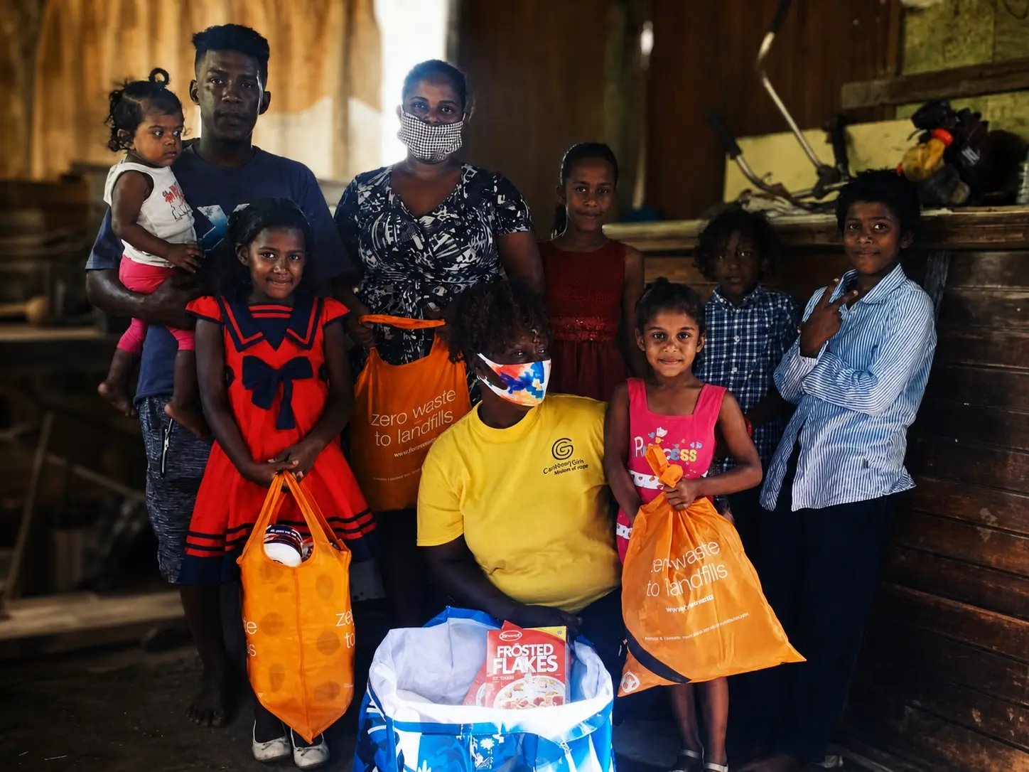 A family receiving food and essential supplies from Caribbean Girls Mission of Hope