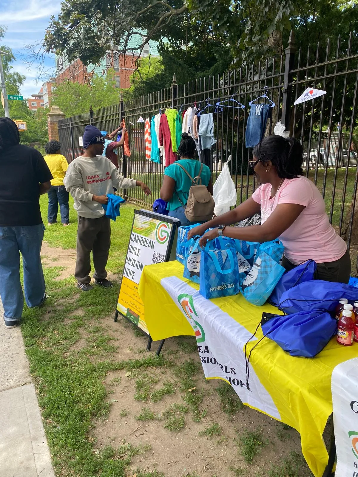 Volunteers prepare blue Father's Day care bags at the CGMOH outreach table