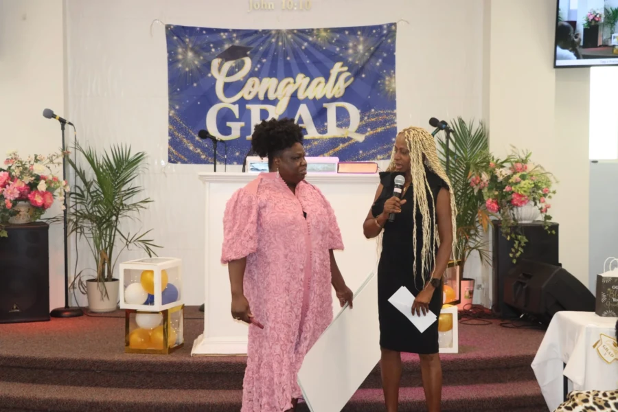 Two speakers address guests during the 2026 scholarship presentation