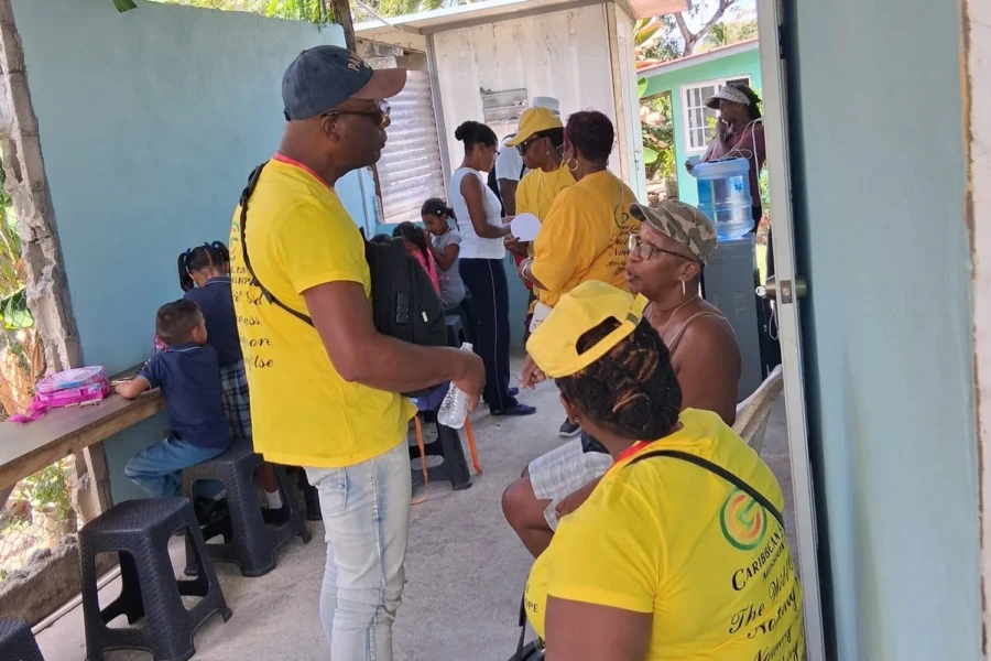 A CGMOH volunteer speaks with a community member during the center outreach