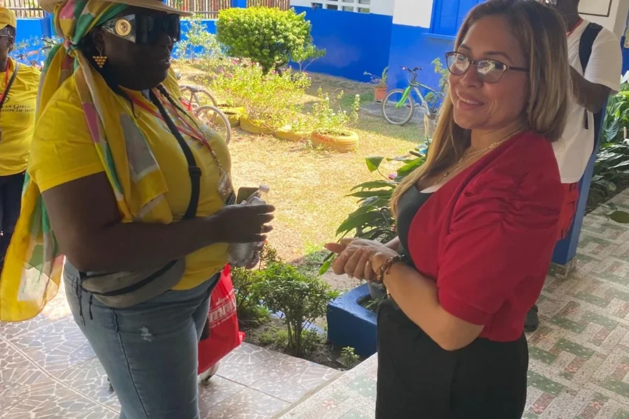 A CGMOH volunteer greets a community partner at the outreach