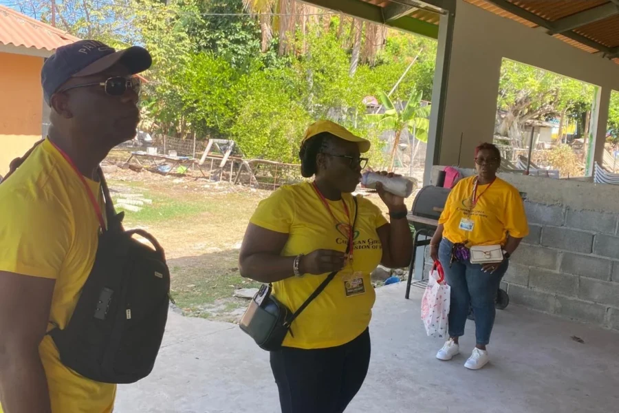 Volunteers walk through the community center grounds in matching yellow shirts