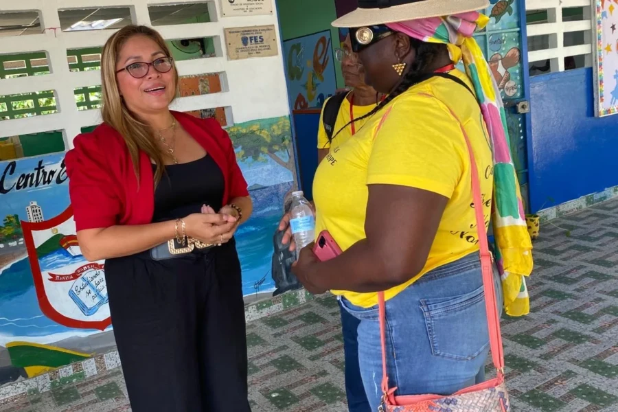 A CGMOH volunteer speaks with a visitor during the activity program