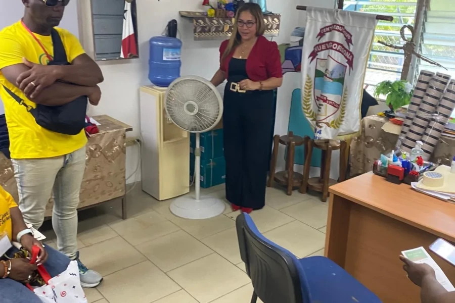 Volunteers meet with the children's center team inside an office
