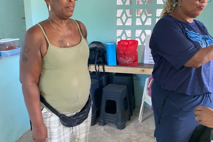 A community member receives support from volunteers during the outreach