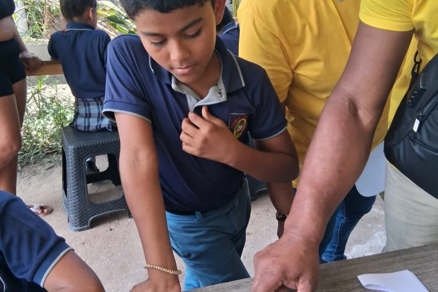 A volunteer assists a student during a hands-on center activity