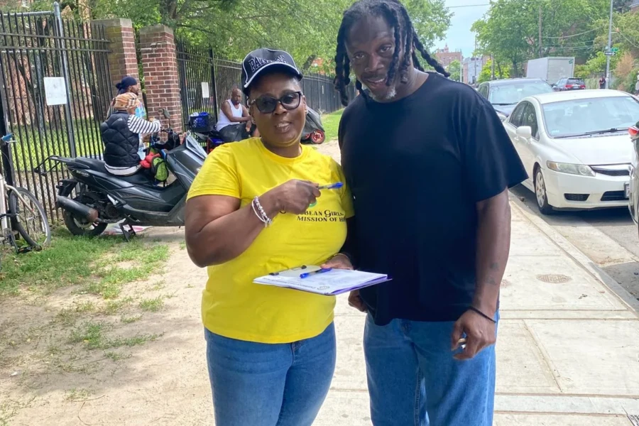 A CGMOH volunteer welcomes a father at the 2026 community giveaway