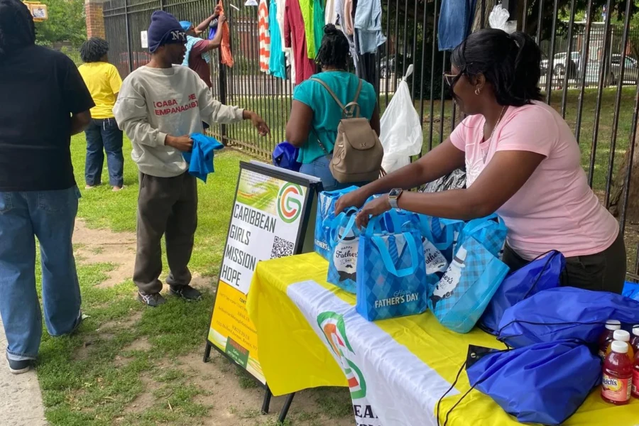 Volunteers prepare blue Father's Day care bags at the CGMOH outreach table