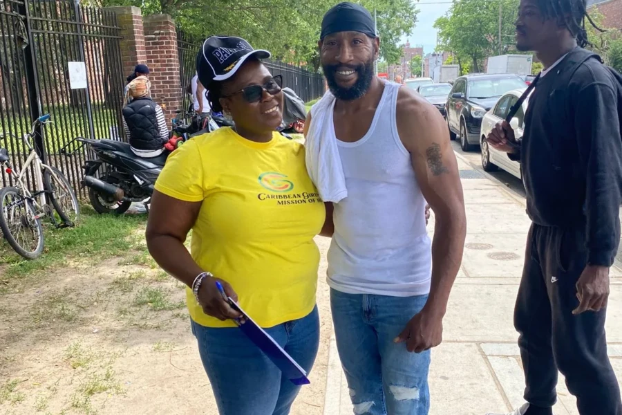 A CGMOH volunteer poses with a community member during the Father's Day outreach