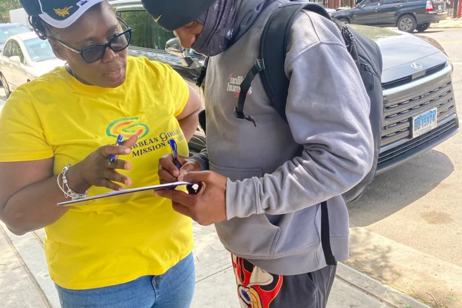 A CGMOH volunteer helps an attendee at the Father's Day registration table
