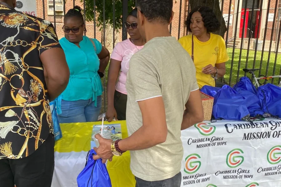 Volunteers distribute blue care bags to community members