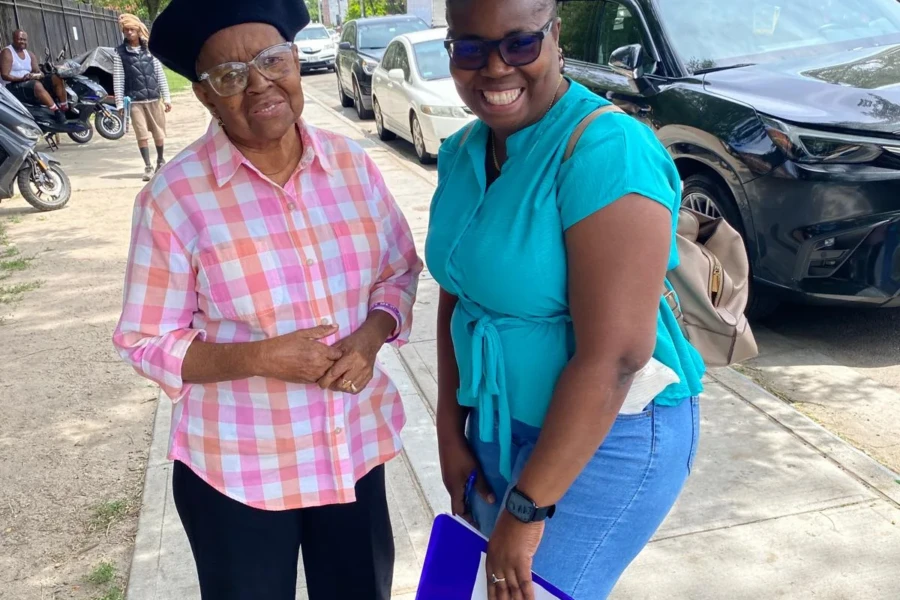 Two community members smile together during the Father's Day outreach