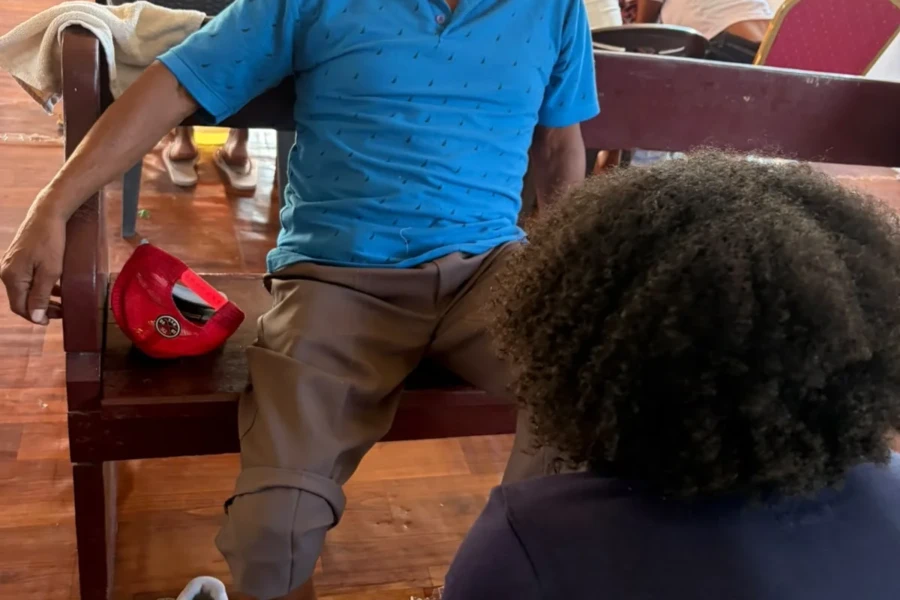 A volunteer provides attentive personal-care support to an older guest