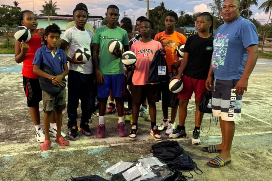 Kawkani youth and community leaders pose with donated sports equipment