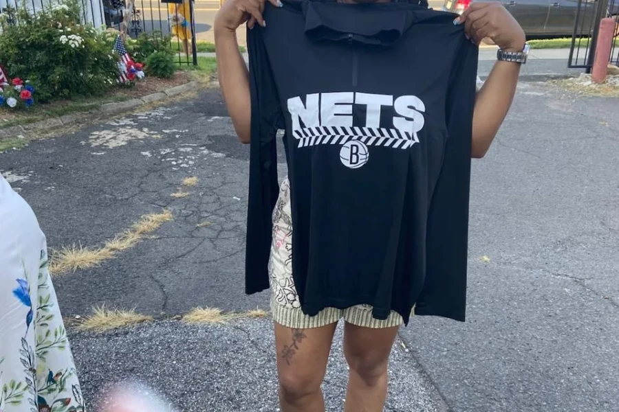 A guest displays a clothing gift received during the Mother's Day outreach