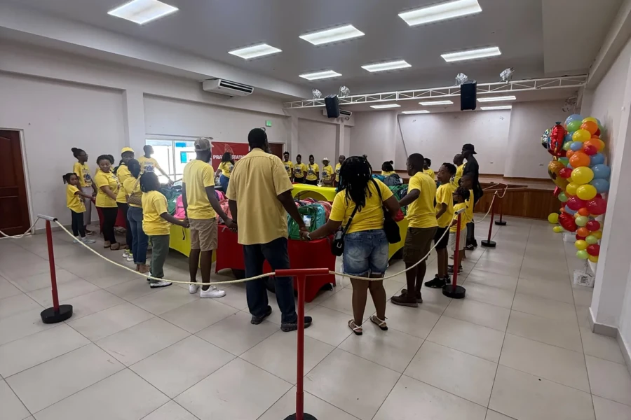 CGMOH volunteers in yellow shirts welcome families inside the outreach venue