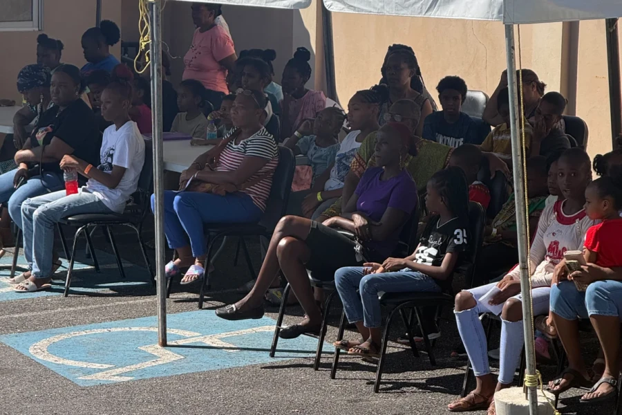 Children and families seated together during the Trinidad community outreach